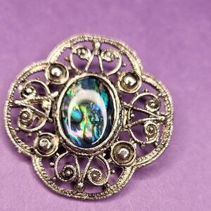 Elegant Silver Filigree Brooch with Iridescent Stone
